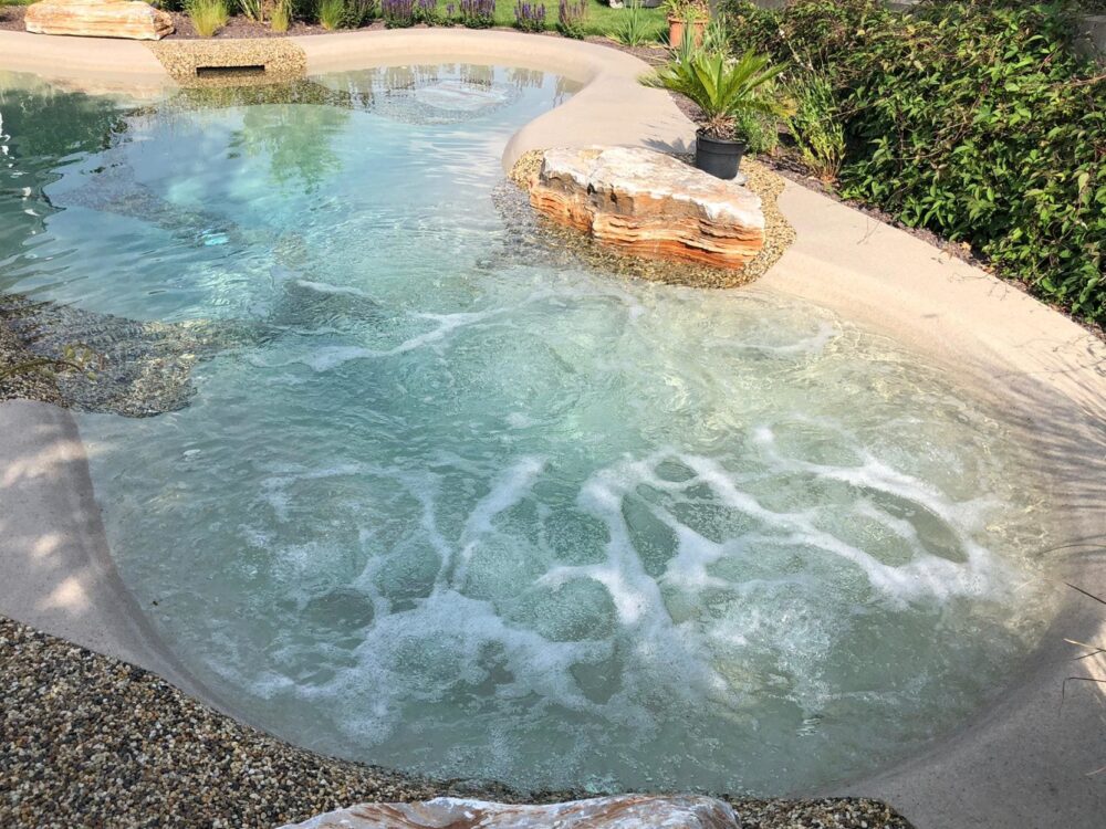 BIO.design Pool in organischer Form in Luftaufnahme mit Felsen